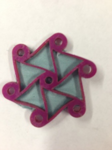 This chiral has rubine red powder with blue dye and blue fabric super glued to the back of it.