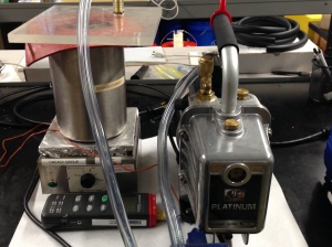 This photo is of the degassing set-up which contains a vacuum pump, a thermocouple, a hot plate, and a degauss chamber.  The thermocouple and the hot plate are used to heat the mixture, below the Tg and above room temperature, while degassing.